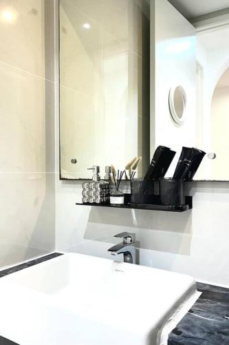 a bathroom with a sink and a mirror at Dooga Ins-Dreamspace L37 Seaview Projector 1-6pax in Johor Bahru