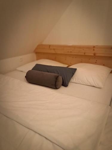 a large white bed with a pillow on it at CHALUPA U ROUBÍČKŮ in Horní Bečva