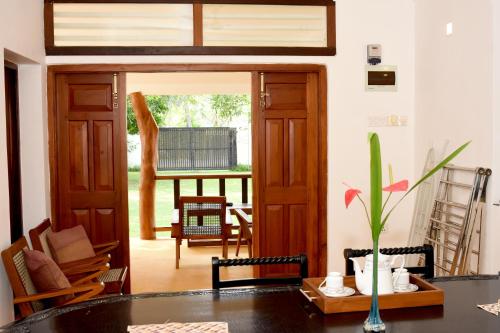 a living room with a table and an open door at Villa Polhena in Matara