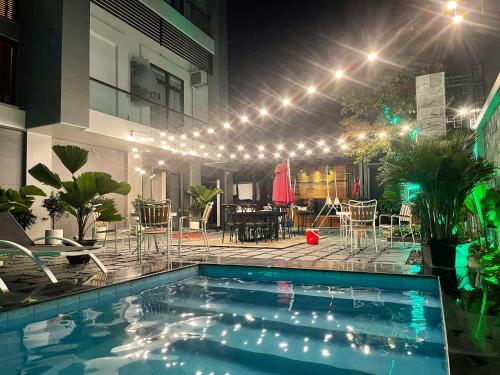 a house with a swimming pool at night with lights at Ken Hotel & Apartment in Hai Phong