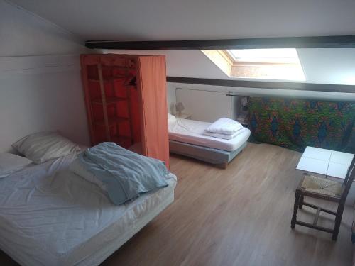 a bedroom with a bed and a bunk bed and a window at Les amandiers in Gigors