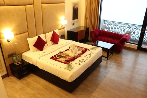 a hotel room with a bed and a red couch at Rosetum Kasauli in Kasauli