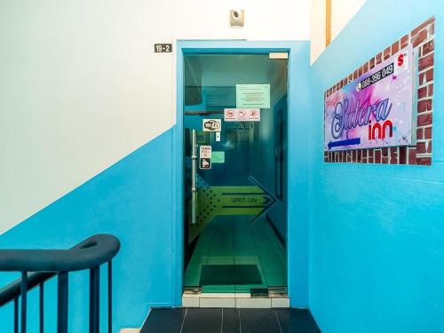 a bathroom with a blue wall and a blue door at Sutera Inn Inanam in Kota Kinabalu