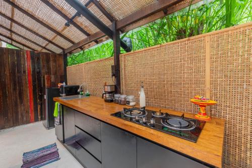 a kitchen with a counter top with a stove top at Calidas Hill in Kintamani