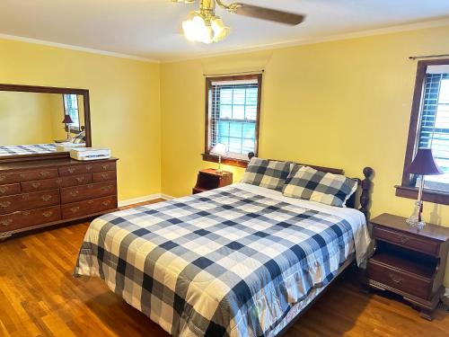 a bedroom with a bed and a dresser and a mirror at Cozy Philly Haven: Ideal Home in Philadelphia