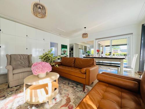 a living room with a couch and a table at The Alice, Mittagong in Mittagong