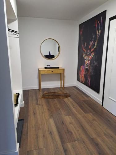 a room with a table and a mirror on a wall at L-Elf in Hauzenberg