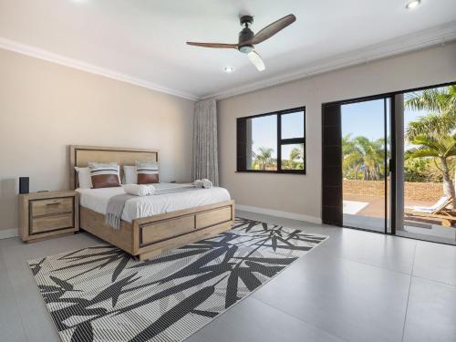 a bedroom with a bed and a ceiling fan at One on Chelsea in Durban