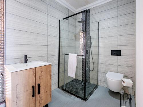 a bathroom with a shower and a toilet and a sink at One on Chelsea by Host Agents in Durban