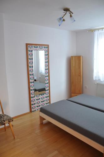 a bedroom with a bed and a mirror at Apartmán pod Veľkou Račou in Oščadnica