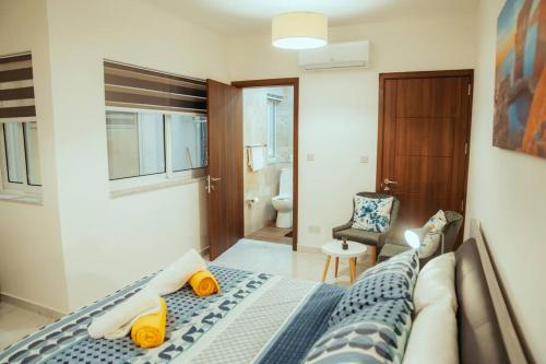 a bedroom with a bed and a bathroom at Luxurious Gozo Apartment, Qala in Qala