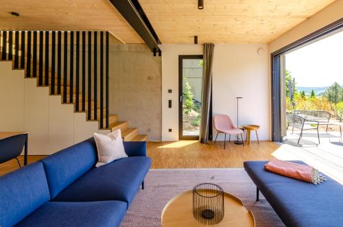 a living room with a blue couch and a table at Sauerland Lodge - Haus Anton in Winterberg
