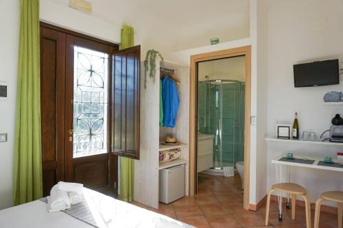 a bedroom with a bed and a bathroom with a shower at Casale Del Borgo in San Severino