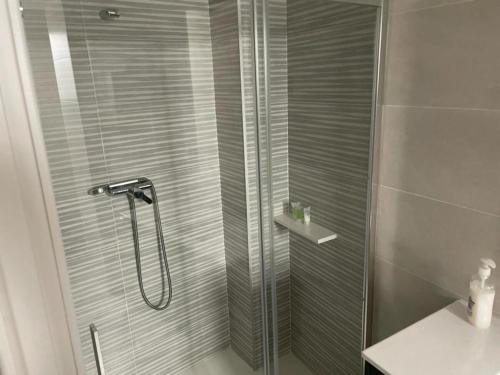 a shower with a glass door in a bathroom at Carbo Home moderno, Algemesi Home in Algemesí