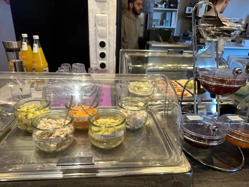 a tray filled with bowls of food in a kitchen at Hotel Zum Goldenen Anker in Bamberg