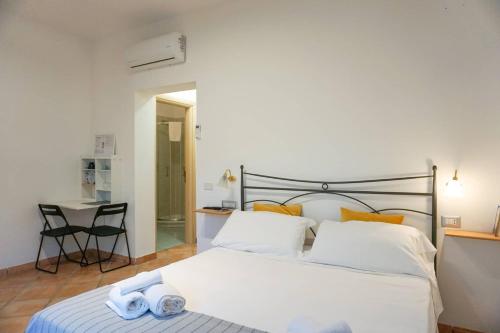 a bedroom with a bed with two towels on it at Casale Del Borgo in San Severino