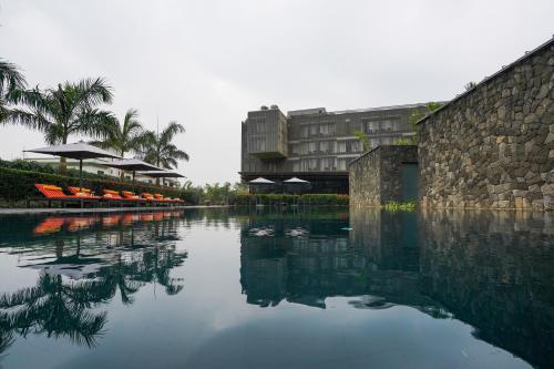 a pool of water in front of a building at Radisson Resort and Spa Lonavala in Lonavala