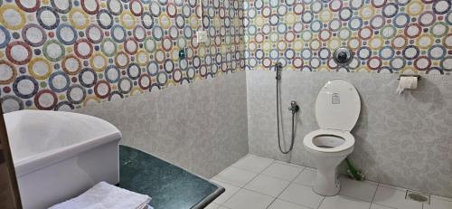 a bathroom with a toilet and a sink and a shower at SERENE VIBE MAJORDA in Goa