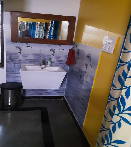a bathroom with a white sink and a shelf at Konnectify Quintuple - 5 Person Room Suite in Coimbatore