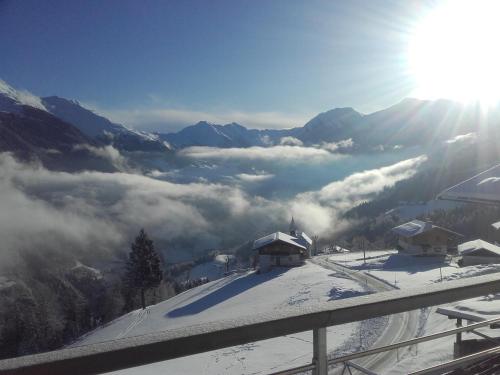 a view of a valley with clouds in the mountains at Joshof Talblick in Stulles