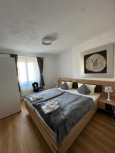 a bedroom with a large bed with a wooden frame at Hotel Zum Goldenen Anker in Bamberg