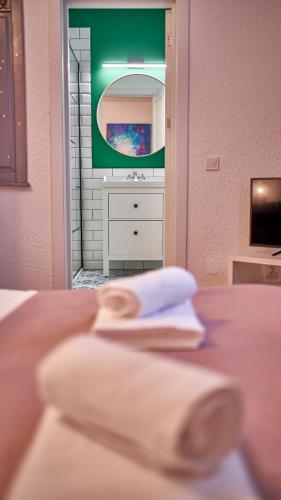 a bathroom with a sink and a table with two towels at Family TreeZ Premium Apartments in Poiana Brasov
