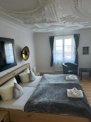 a bedroom with a large bed with two towels on it at Hotel Zum Goldenen Anker in Bamberg