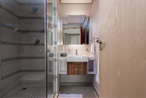 a bathroom with a sink and a shower at Iconic Pearls of Umhlanga in Durban