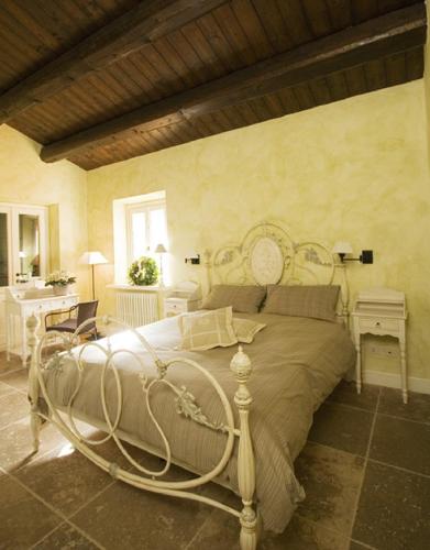 a bedroom with a large bed in a room at Country House Il Sassòne in Camerano