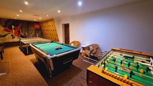 a room with a pool table and ping pong balls at Penzion Zvonička in Pec pod Sněžkou