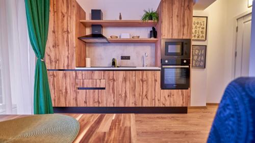 a kitchen with wood paneling and a stove top oven at Family TreeZ Premium Apartments in Poiana Brasov