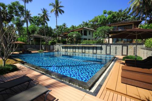 a swimming pool in a yard with a house at Niramaya Villa & Wellness in Ko Yao Noi