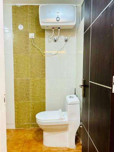 a bathroom with a white toilet and a sink at The Starfish Studio , Mussoorie road in Dehradun