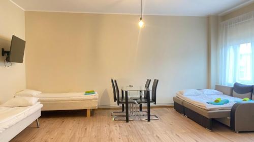 a room with a bed and a table and chairs at Kastanimaja Apartments in Tartu