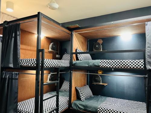 a bunk bed room with four bunk beds in it at Empire Hostel Regalia in Kuala Lumpur