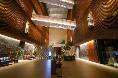 a large room with wooden walls and a lobby at Radisson Resort and Spa Lonavala in Lonavala