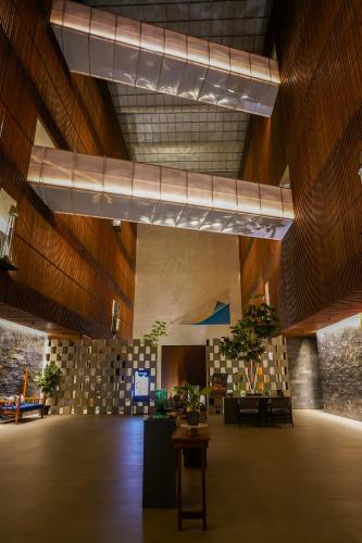 a large room with wooden walls and ceilings with potted plants at Radisson Resort and Spa Lonavala in Lonavala
