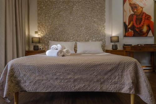 a bedroom with a bed with two towels on it at Grand Large - cosy studio in Papeete