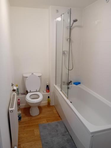 y baño blanco con aseo y ducha. en Apartment closer to the city centre en Mánchester