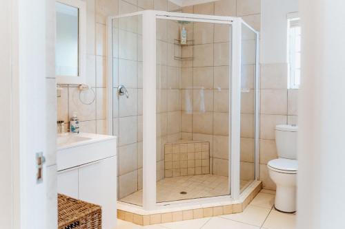 a shower with a glass door in a bathroom at Sterretjie in Paternoster