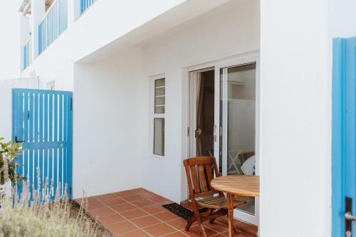 a dining room with a table and a blue fence at Sterretjie in Paternoster