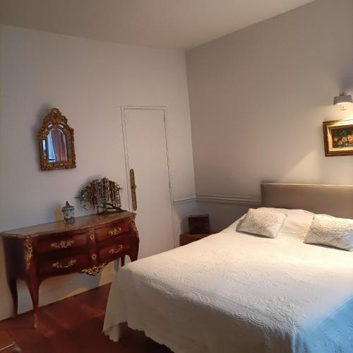 a bedroom with a bed and a dresser and a mirror at ILE SAINT LOUIS 2 CHAMMBRES 2 SALLE DE BAINS PARKING in Paris