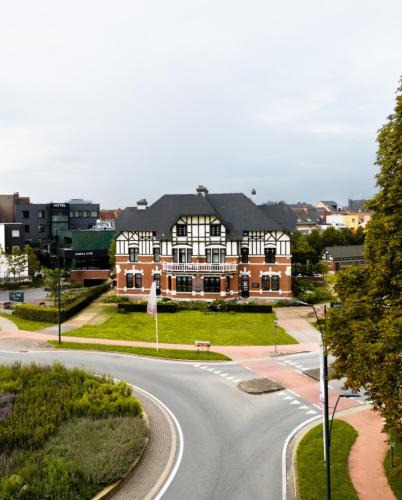a house on a street with a winding road at Porta Cité in Maasmechelen