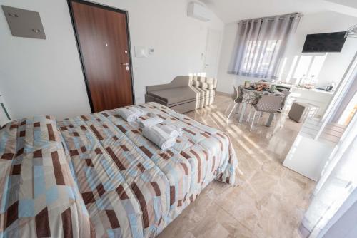 a bedroom with a bed and a living room at B&B Il Risveglio del Cavaliere in Gioia dei Marsi