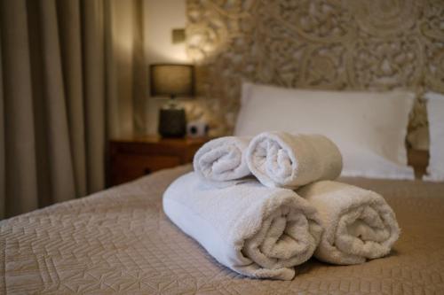 a pile of towels sitting on top of a bed at Grand Large - cosy studio in Papeete