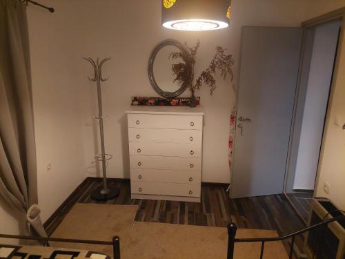 a bedroom with a dresser with a mirror and a lamp at Simbas House in Leonidion