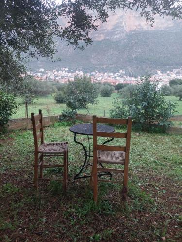 a table and two chairs sitting next to a table at Simbas House in Leonidion