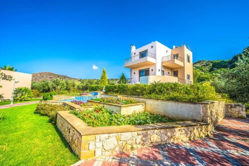 a house with a garden in front of it at Anemon Villas in Kissamos