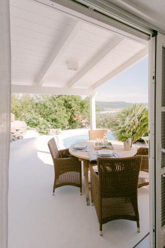 an outdoor patio with a table and chairs at PAVI APARTMENTS Life Style House with private pool in Kornić
