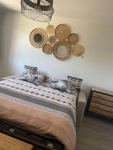 - une chambre avec un lit et des paniers sur le mur dans l'établissement Le Charmeur * * *, à Aurillac